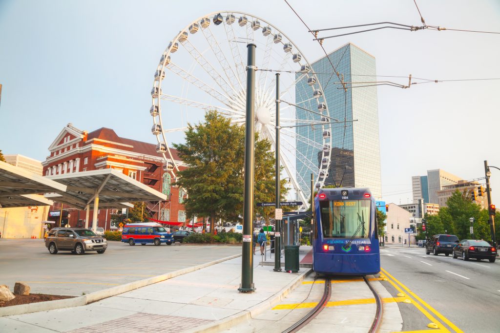 The Atlanta Streetcar on Centennial Olympic Park Drive with Skyview Atlanta and The Tabernacle in the background