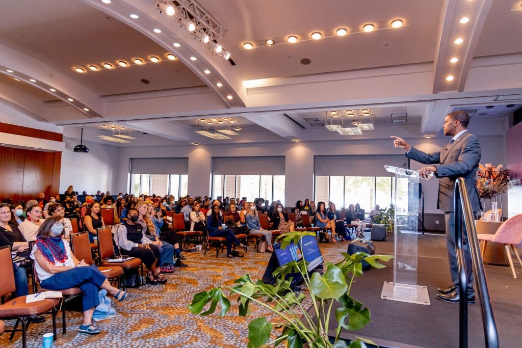 Speaker addressing a full audience during a mission-driven event at Loudermilk Conference Center in Atlanta.